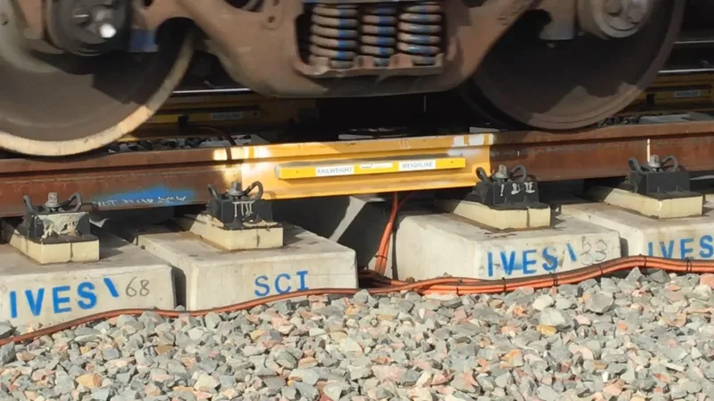 A close up image of Railweight Weighline train scales on a rail