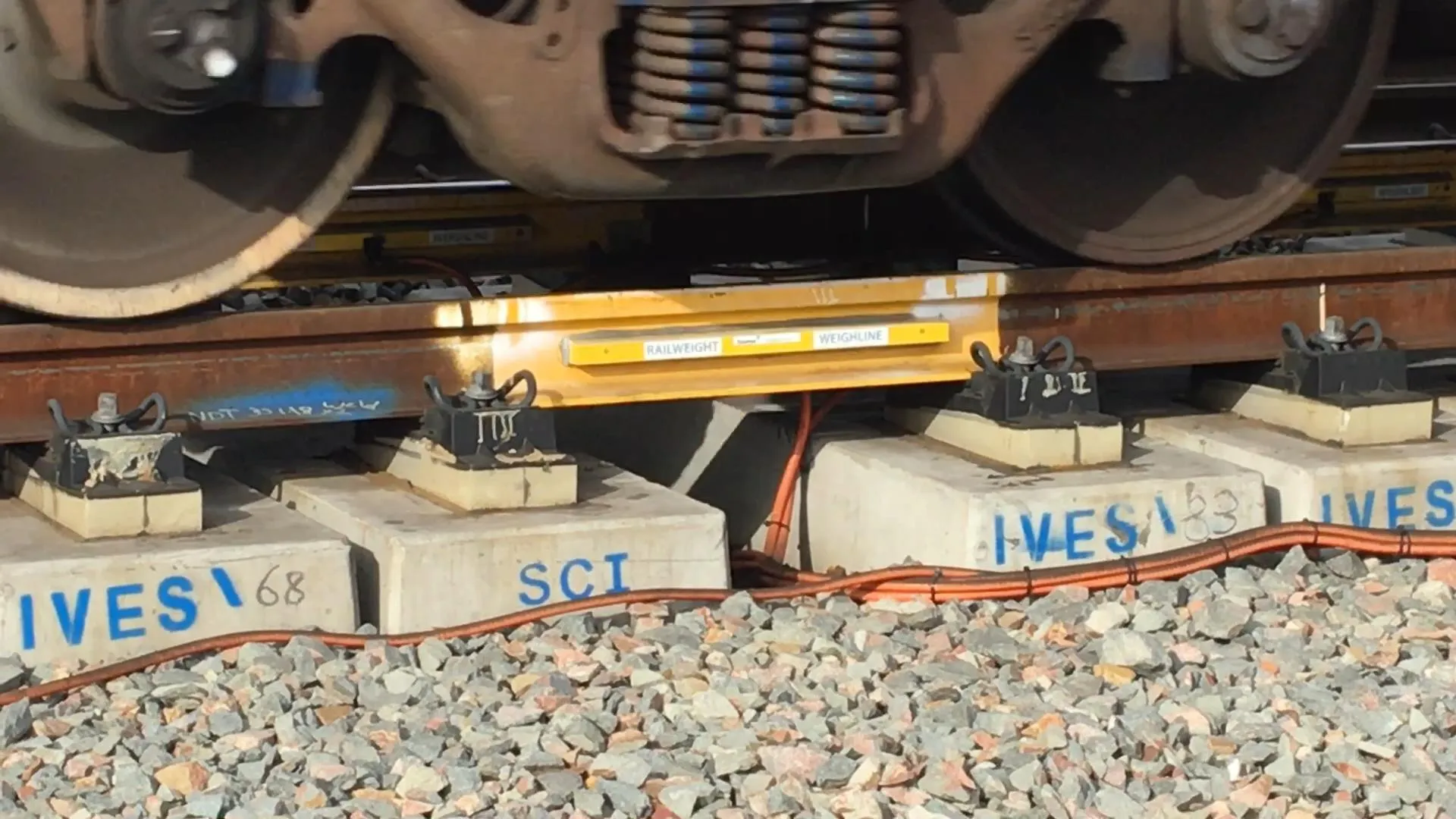A close up image of Railweight Weighline train scales on a rail